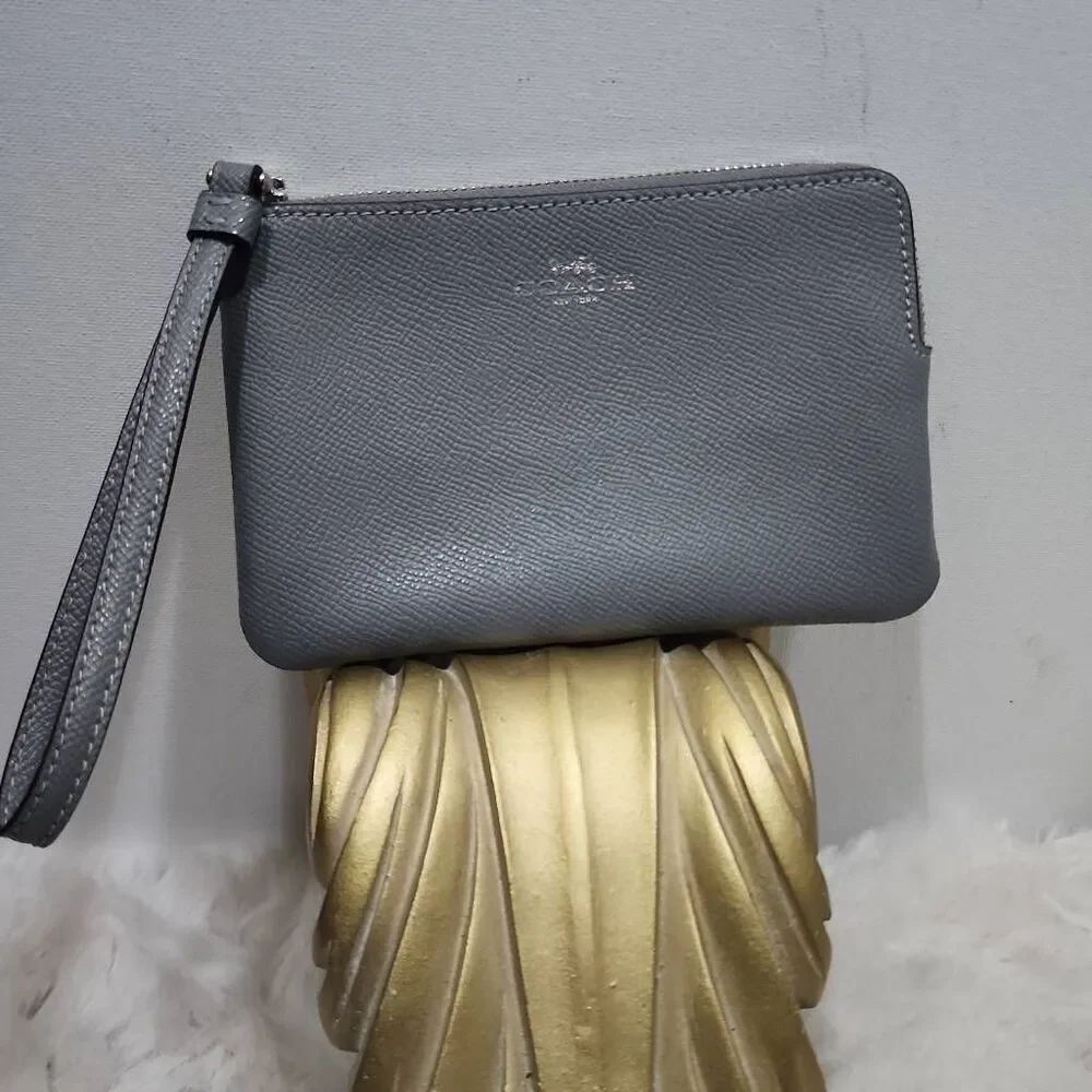 Coach Corner Zip Wristlet in a grey crossgrain leather.